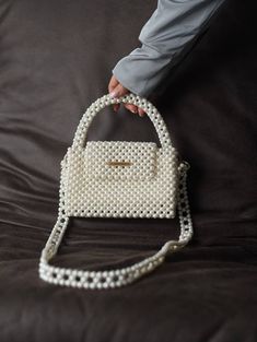 Handcrafted Beaded Pearl Bag - Elegance in Every Bead Unveil the epitome of timeless glamour with our exquisite Beaded Pearl Bag--a fusion of sophistication and craftsmanship that's perfect for the modern-day diva. Whether you're attending a wedding, a gala, or a stylish soirée, this beaded pearl bag is designed to elevate your outfit. It effortlessly transitions from day to night, making it a versatile accessory for every occasion. Despite its petite appearance, this bag is surprisingly spaciou Timeless Glamour, Wedding Handbag, Pearl Bag, Bride Gift, Classic Bags, Fishing Line, Unique Bags, Magnetic Clasp, Black Bag