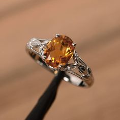 It is a natural citrine ring. The main stone is 7mm*9mm oval cut, weight about 1.77 carats. The basic metal is sterling silver and plated with rhodium. To change the metal to a solid gold (white/rose) or platinum is also available, please ask for a quotation if you want. You can also go to my shop Home for more elegant rings: https://www.etsy.com/shop/godjewelry?ref=hdr_shop_menu More citrine rings: https://www.etsy.com/shop/godjewelry?ref=seller-platform-mcnav&section_id=20715039 Customization Amber Engagement Ring, Citrine Wedding Ring, Silver Solitaire Engagement Ring, Yellow Gemstone Ring, Citrine Ring Engagement, Elegant Rings, Happy Families, Blue Aquamarine Ring, Marquise Cut Engagement Ring