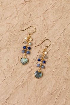 Discover the vibrant and stunning colors of the Blue Moon Collection in these eclectic earrings! Gold Filled (Lead & Nickel Free) Mother Of Pearl, Lapis Lazuli, Labradorite 1.75" with gold filled ear wires We hand select our natural materials, thus there may be slight variations in color and/or size that will not detract from the overall aesthetic. Our unique handcrafted designer jewelry for women is made in America, each design created individually in our personal design studio in Floyd, VA USA Blue Bohemian Heart Earrings For Gift, Blue Bohemian Heart Earrings As Gift, Bohemian Blue Heart Earrings For Gifts, Bohemian Blue Heart Earrings As Gift, Blue Handmade Heart Dangle Earrings, Handmade Blue Heart Dangle Earrings, Blue Heart Charm Drop Earrings, Eclectic Earrings, Floyd Va