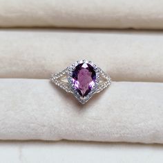 Main Stone : Natural purple amethyst Stone Color : Pink Stone Size : 10x7 mm Stone Shape : Pear Side Stone : American diamond Metal : 925 Sterling Silver Setting type : Prong setting Occasion : Engagement, Wedding ,Party, Anniversary, Valentine's Day, Daily Style : Classic Rings Type : Halo Ring Item Type : Ring Plating :silver/ gold/rose gold If You Have Any Questions, Please Feel Free Contact Us through Etsy Message Service If you want to make jewelry of some other design or other types please