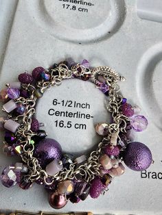 Purple, beaded bangle charm bracelet. Silver Bracelets With Round Beads As Fashion Accessory, Elegant Beaded Dangle Charm Bracelet, Elegant Bracelet With Dangling Beads For Gift, Silver Beaded Bangle Charm Bracelet, Beaded Dangle Bracelets As Gifts, Metal Beaded Dangle Charm Bracelet, Metal Beaded Bracelets For Gifts, Metal Beaded Charm Bracelet Gift, Colorful Beaded Metal Bracelet