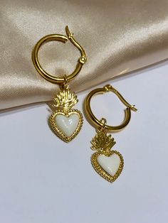 Are you looking for the perfect Valentine's day heart hoop earrings for someone special this Valentine's season? Or a unique pair of sacred heart earrings to spoil yourself? Made with tarnish-free and gold-plated stainless steel hoops and bright enamel, my vintage-style sacred heart earrings are the perfect compliment to any outfit idea! My heart dangle hoop earrings are a great gift idea for any special occasion to all the women in your life. You can't go wrong when gifting my Valentine's day e White Heart Pendant Earrings For Valentine's Day, White Pierced Heart Earrings For Valentine's Day, White Heart Pendant Earrings As Gift, White Heart Pendant Earrings For Gifts, White Heart Pendant Earrings, White Open Heart Earrings For Gift, Gift White Open Heart Earrings, Heart Charm Hoop Earrings As Gift, Heart Charm Hoop Earrings For Gift