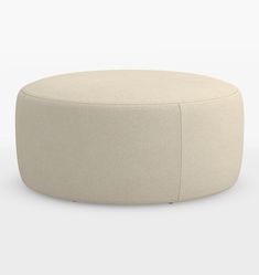 a white round ottoman sitting on top of a floor