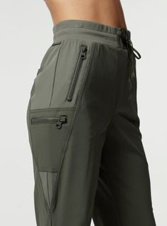 FEATURES & BENEFITS The Mastermind 2.0 pants are an absolute wardrobe essential. These cargo-inspired pants are technical knit material for an on-trend look. Features zipper pockets and an adjustable waistband. For a matching set look pair with the Mastermind 2.0 jacket. Adjustable Waist With Functional Drawcord Functional Zip Pocket Inseam 28" FABRIC CONTENTS Self : Technical Knit 77% Nylon 23% Spandex Contrast Our Technical Mastermind Fabric is a dry to the touch 77% Nylon/23% Spandex fabric t Pocket Joggers Outfit, Colored Pants Outfits, Adjustable Pants, Zip Off Pants, Pocket With Zipper, Track Pants Mens, Walking Outfits, Functional Clothing, Pants Pocket