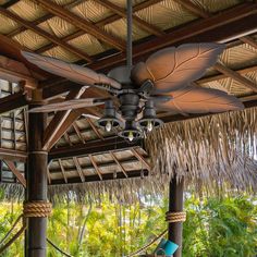 a ceiling fan hanging from the side of a wooden structure