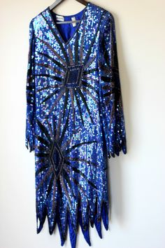 "Fun and funky Vintage Sequin Flapper inspired dress..timeless style for your one of a kind type of night.. This slips over the head. All the beads and sequins are in Very Good condition..i do not see any missing..although i might have missed something..this is all silk..beads and sequins. Lovely Zig zag hem. This is very small. It is a straight dress..so if you want it to fit loose, remember those measurements. Measuring: 36\" - 38\" long (zig zag hem) Sleeves: 22\" Width: Bust/hip/waist: 34\" Fitted Art Deco Party Dresses, Vintage Flapper Dress For Evening Party Season, Art Deco Fitted Dress For Night Out, Vintage Embellished Flapper Dress For Costume Party, Vintage Embellished Flapper Dress For Party, Fitted Art Deco Flapper Dress For Night Out, Vintage Flapper Dress For Night Out And Party Season, Costume Dresses With Sequins For Party Season, Blue Fitted Dress For Carnival