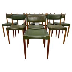 six green leather chairs with wooden legs and backrests, all in the same pattern