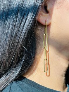 Say hello to these impressive Paperclip Chain Earrings that are exclusively handcrafted. Our dangling earrings will suit even the most minimalist woman; a simple geometric design comes together to create these statement pieces. Paperclip Chain Earring Details: Metal: 14K Gold Plated on Stainless Steel Hypoallergenic, Tarnish-Free. Length: 8.5cm Perfect your Parure by pairing with our Zirconia Pendant Necklace and Single Diamond Bezel Bracelet. Minimalist Paperclip Chain Dangle Earrings, Modern Box Chain Earrings As Gift, Modern Box Chain Earrings For Gift, Modern Link-style Earrings With Box Chain, Yellow Gold Link Earrings For Everyday, Everyday Yellow Gold Link Earrings, Minimalist Dangle Paperclip Chain Jewelry, Yellow Gold Paperclip Earrings For Gift, Elegant Everyday Earrings With Paperclip Chain