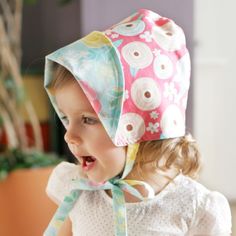 Kinderspel Boutique Style Bonnet Bonnets are a perfect accessory for babies and toddlers to keep hair under control and keep sun off their cute little faces. These Kinderspel bonnets come in the cutest floral patterns that are sure to make your little one the most stylish on the block. This cap features two layers of lightweight, easy-care cotton and a big brim to protect from wind and sun, as well as an easily adjustable closure to ensure baby is comfortable. Other Details: One size: 19-20” Age Cute Pink Cotton Bonnet, Cute Pink Hat For Play, Whimsical Adjustable Hats For Playtime, Adjustable Whimsical Hats For Playtime, Handmade Cute Pink Bonnet, Cute Handmade Pink Bonnet, Adjustable Pink Bonnet As Gift, Cute Pink Bonnet For Spring, Cute Pink Hat For Playtime