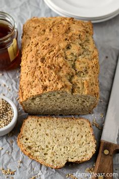 a loaf of bread sitting on top of a table next to a knife