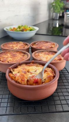 a pan filled with food cooking on top of a stove