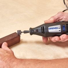 a man is using a drill to fix a piece of wood with a cordless screwdriver