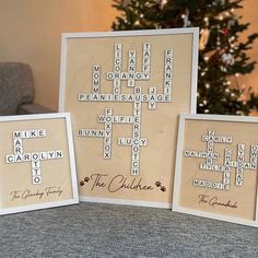 three framed crosswords are sitting next to a christmas tree