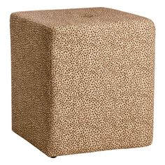 a brown and white animal print cube stool with the seat up on it's side