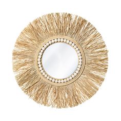 a round mirror that has some kind of straw decoration on top of it, with beads around the edges