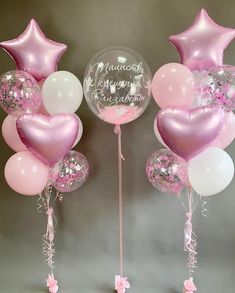 pink and white balloons are in the shape of hearts