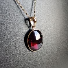 ITEM DESCRIPTION: >> The Pendant is made from Solid 14K Yellow Gold. Gemstone used is absolutely natural and ethically sourced. >> Natural Garnet in cabochon cut and oval shape with bezel setting is studded on it with utmost precision. >> This is a minimalist design and is absolutely hassle-free and everyday jewelry. Gem: Garnet Gem size: 12x14 mm oval Gem weight: 6.33 carats Gold purity: 14K (58.33% approx.) Gold weight: 0.49 grams Gross weight: 1.76 grams The Gold purity is guaranteed and it c Round Pendant Hallmarked Gemstones As Gift, Hallmarked Round Pendant Gemstones For Gifts, Elegant Oval Garnet Necklace, Yellow Gold Garnet Necklaces With Oval Shape, Yellow Gold Oval Garnet Necklace, Oval Garnet Necklaces For Anniversary, Oval Garnet Necklace For Anniversary, Elegant Faceted Ruby Gemstones, Elegant Ruby Gemstones As Gift