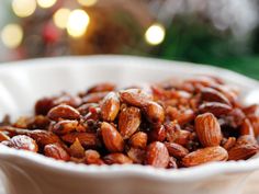 a white bowl filled with nuts on top of a table