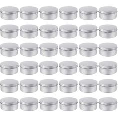 a large group of silver tins on a white background