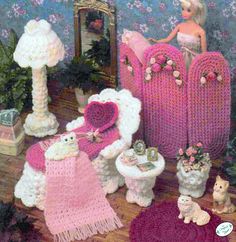 a crocheted doll house with furniture and accessories on the floor in front of a mirror