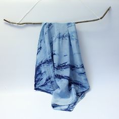 The small silk scarf made of soft, light Crepe de Chine is hand-dyed in Kumo Shibori design with indigo. Crepe de Chine has a smooth surface with fine highlights, which makes the cloth look very noble. Wear it as a scarf or as a bandana in your hair or around your wrist. 100% Crepe de Chine Silk approx. 55 cm x 55 cm hand-dyed with indigo in Kumo Shibori design rolled hem Blue Bohemian Scarf With Natural Dye, Bohemian Blue Scarf With Natural Dye, Blue Hand Dyed Silk Scarf For Summer, Hand Dyed Blue Silk Scarf For Summer, Summer Hand Dyed Blue Silk Scarf, Blue Hand-dyed Silk Scarf For Summer, Blue Bohemian Hand Dyed Silk Scarf, Blue Bohemian Hand-dyed Silk Scarf, Fine Highlights