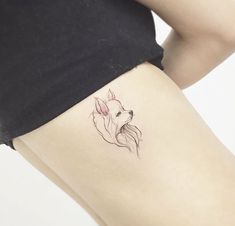 a woman's thigh with a small tattoo of a dog on her left side