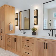 a large bathroom with double sinks and mirrors