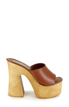 A woodgrain platform and soaring block heel lend scene-stealing height and retro-cool appeal to a slide sandal that will elevate your trendsetting looks. 4" heel; 2" platform Leather upper and lining/synthetic sole Made in Spain Summer Clogs With Chunky Platform And Block Heel, Modern Platform Slippers With Stacked Heel, Modern Platform Slippers With Stacked High Heel, Summer Platform Slippers With Sculpted High Heel, Spring Clogs With 4-inch Wedge Heel, Trendy Summer Clogs With Deep Heel Cup, Spring Platform Slippers With Wooden High Heel, Spring High Heel Platform Slippers With Wooden Heel, Brown Open Toe Clogs With 4-inch Heel