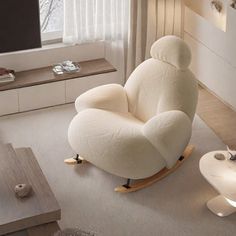 a white rocking chair in a living room