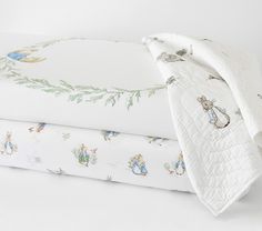 the bedding is white and has peter rabbit designs on it