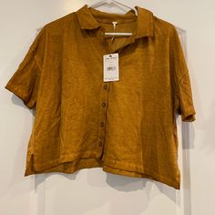 Cropped Button Up Shirt. Lose Fitting And Soft Material. Never Been Worn! The Color Is Called Copper. Orange Collared Tops For Summer, Brown Button-up Summer Tops, Summer Brown Button-up Tops, Trendy Orange Cotton Blouse, Casual Collared Orange Blouse, Casual Orange Collared Blouse, Orange Short Sleeve Top With Buttons, Orange Casual Short Sleeve Blouse, Casual Short Sleeve Orange Blouse