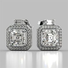 This beaming set of earrings will have you mesmerized by its whimsical design. A stunning pave halo complete with beadedmilgrainsurrounds our dazzling Asscher cut simulated diamonds. Further embellished by a brilliant baguette stone set over the top of each stunning earring. A perfect gift.   Asscher Cut Halo Earrings;  Center Stone: 1.5CT Each;  Total Carat Weight: 3.38CTW;  Stone Clarity: VVS-1;  Available in: 14K White Gold;  Model:ER2497-WH; Luxury Cubic Zirconia Diamond Earrings With Halo Design, Dazzling Sterling Silver Bridal Earrings With Pave Setting, Dazzling Halo Cubic Zirconia Diamond Earrings, Dazzling Cubic Zirconia Halo Diamond Earrings, Luxury Cubic Zirconia Halo Earrings, Dazzling Cubic Zirconia Diamond Earrings With Halo, Luxury Silver Diamond Earrings With Halo, Luxury Silver Halo Earrings, Diamond Bridal Earrings With Pave Setting