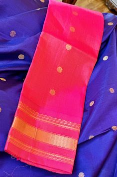 This beautiful Gadwal Silk Saree is a classic handwoven piece crafted using the finest silk. Show off your style in this elegant saree, featuring navy blue with buttis on the body while the kuttu borders and the grand pallu in two tone pink. The matching blouse piece is in two tone pink. Perfect for any special occasion, you'll love the quality and finish of this gadwal saree. Approximate Length 6.5 mtrs (inclusive of blouse length) Approximate Height - 48 - 52" Approximate weight - 1.6 lbs Saree comes with fall, picot and tassels done when applicable. Blouse piece is cut. Kindly Note : The colors you see on your device may vary due to the color reproduction, brightness and resolution of individual devices. If you'd like more clarity before your purchase, please contact our support team. Silk Cotton Sarees, Elegant Saree, Cotton Sarees, Blouse Length, Support Team, Cotton Saree, Blouse Piece, Silk Blouse, Silk Saree