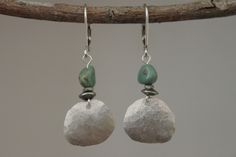 These lovely boho earrings are made of sterling silver discs hand hammered and  genuine turquoise nugget stones. They hang from sterling silver leverbacks. There are small and lightweight, comfortable and easy to wear as an everyday earrings. Leverbacks keep your earrings on securely by creating a closed loop. Very unique handmade earrings ( only one ! ) and ready to ship ! You will receive exactly the same earrings as shown in the pictures. Color : Genuine turquoise nuggets stones ( 6mm ) Finish : hand hammered from sterling silver discs, sterling silver leverbacks, sterling silver eye pins and antique silver tone spacer beads. Length : 1 1/2 inches from the top of the ear wires to the bottom Ear wires : Sterling silver leverbacks For more choices on my sterling silver earrings, please re Silver Turquoise Earrings, Unique Handmade Earrings, Silver Eye, Hammered Earrings, Earring Ideas, Eye Pins, Ethnic Earrings, Genuine Turquoise, Small Earrings