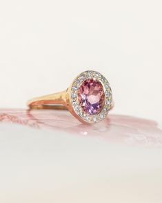 *One of a Kind* hand-carved 14k Yellow Gold ring, set with a stunning oval Pink Tourmaline, surrounded by a halo of White Diamonds. Center Tourmaline is approx. 6 x 8mm and 1.38 ct. Created to inspire deeply devoted unconditional love, reminding you of your innate worthiness and beauty, and to harmonize your strength, softness and power. Natural inclusions may be present within the stone. 💌 Please write desired size (between 4-8) in *Notes* section at checkout. * Pink Tourmaline is amazing for Oval Tourmaline Halo Setting Jewelry, Oval Tourmaline Jewelry With Halo Setting, Heirloom Oval Sapphire Ring With Halo Design, Oval Tourmaline Ring With Center Stone, Oval Sapphire Ring With Halo Setting In Heirloom Style, Heirloom Oval Halo Ring With Bezel Setting, Beacon Of Light, Inner Light, Love Yourself First