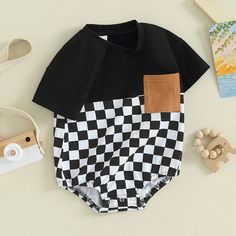 Your little critter will be the most dapper on the block in this OLIVER Checkered Short-Sleeve Onesie! Perfect for summer, this onesie is perfect for your little man no matter what his summer adventure holds! Available in two colors, he's sure to look as handsome as he is handsomely comfortable! Family Matching Black Cotton Onesie, Black Cotton Short Sleeve Bodysuit For Summer, Black Cotton Onesie For Spring, Black Summer Onesie For Playtime, Spring Cotton Black Onesie, Black Short Sleeve Onesie For Summer, Spring Black Cotton Onesie, Black Playful Bodysuit For Casual Wear, Black Cotton Onesie For Summer