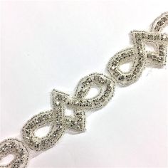 This beautiful trim is made of high-quality clear rhinestones. It is perfect for all special occasions. It can be used for wedding dress, wedding belts and sashes, bridesmaid sashes ;hats, headbands, flower bouquet wrap, wedding invitation, gowns, hair accessory, craft, jewelry, cake decoration, bags, scrapbook or any other decorations. Applying Method: Sew on, Glue on Color: Silver gold Size: Width: 1 Inches Length: 1 Yard Please contact us for wholesale quantities and pricing. Formal Crystal Sashes With Rhinestones, Formal Crystal Sash With Rhinestones, Formal Crystal Rhinestone Sash, Elegant Beaded Silver Sashes, Silver Crystal-embellished Bridesmaid Sash, Elegant Silver Beaded Sash, Elegant Rhinestone Bridal Belt For Bridesmaids, Elegant Silver Embellished Bridal Belt, Formal Silver Crystal Bridal Belt