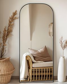 a mirror sitting on top of a wall next to a chair