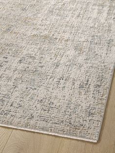 an area rug with white and gray colors