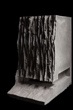 a black and white photo of an object made out of wood sticks on a piece of plywood