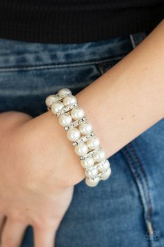 Pairs of pearly white beads and white rhinestone encrusted silver fittings are threaded along an invisible wire around the wrist for a refined flair. Features an adjustable clasp closure. Sold as one individual bracelet. Pink Bubbles, White Bracelets, Jewelry Show, Paparazzi Accessories, Stretchy Bracelets, White Jewelry, White Rhinestone, Bracelet Clasps, Paparazzi Jewelry