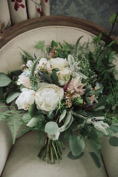 a bouquet of flowers sitting on top of a chair