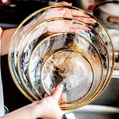 a person holding three plates in their hands