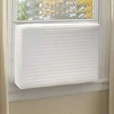 a white mattress sitting on top of a window sill