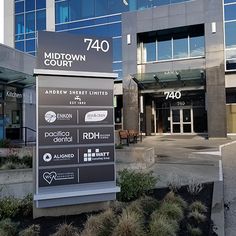 the front entrance to midtown court, an apartment building in downtown vancouver with large glass windows