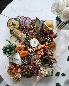 a table topped with lots of different types of cheese and crackers on top of it