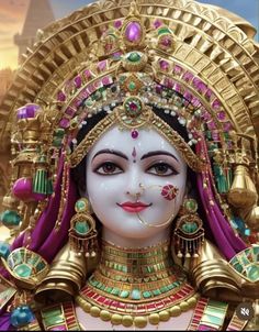 a close up of a statue of a woman wearing gold and green jewelry on her face