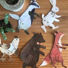 several wooden animals are sitting on a table