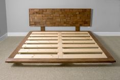 a bed frame made out of wood with no headboard or foot board on it