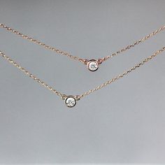 • .167 carats (3.5mm) diamond, SI2, G-H, 100% conflict free• 14k yellow gold or rose gold• 18 inch chain A gorgeous, round brilliant diamond is set entirely in 14k gold and hung in the center of a 14k gold chain in this solitaire necklace. You can choose between 14k yellow gold and 14k rose gold. The diamond is .167 carats (1/6 carat), SI2, G-H in color, and 100% ethical and conflict free. The diamond pendant measures 4.6mm across and the total length of the necklace is 18 inches. This necklace Rose Gold Diamond Necklace With Single Cut Diamonds, Cubic Zirconia Rose Gold Necklace For Anniversary, Round Rose Gold Diamond Necklace, 14k Rose Gold Jewelry With Diamond Accents Round Cut, Rose Gold Diamond Solitaire Necklace With Round Pendant, Rose Gold Solitaire Diamond Necklace With Round Pendant, Rose Gold Solitaire Necklace With Single Cut Cubic Zirconia, Rose Gold Solitaire Necklace With Diamond Cut Cubic Zirconia, Anniversary Rose Gold Diamond Necklace With Single Cut Diamonds